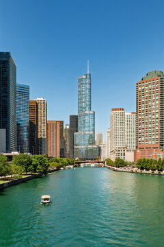 Chicago River with numerous tourist boats. Trump Tower is seen in the middle of the image. River Esplanade Park is on the right and Chicago Riverwalk is on the left. Copy space is in the image.