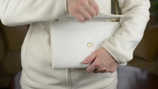 Opening and Closing Magnetic Clasp Fastener on White Female Handbag with Sound