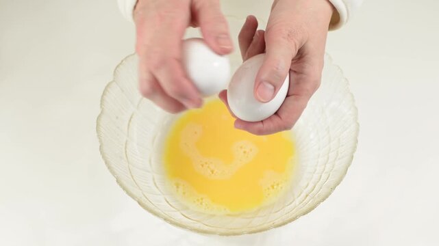 Cracking Two Fresh White Eggs Against Each Other Close Up with sound