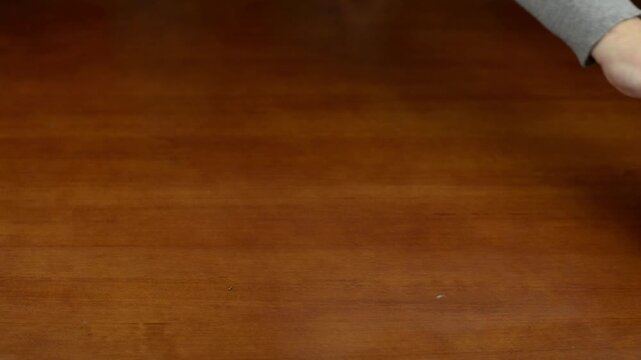Apple rolling across a wooden table surface with sound