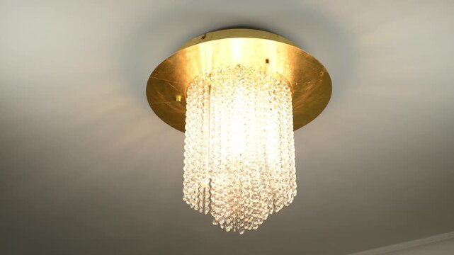 Clinking and delicate tinkling of glass crystal beads of a luxury crystal flush mount ceiling light with sound
