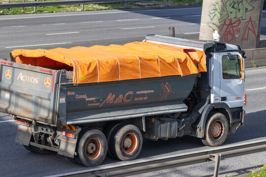 Mercedes benz actros dump truck driving on highway