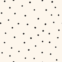 Tossed small black dots on cream white Seamless Vector Pattern Hand Drawn polka dots background © Kateryna