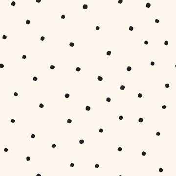 Tossed small black dots on cream white Seamless Vector Pattern Hand Drawn polka dots background