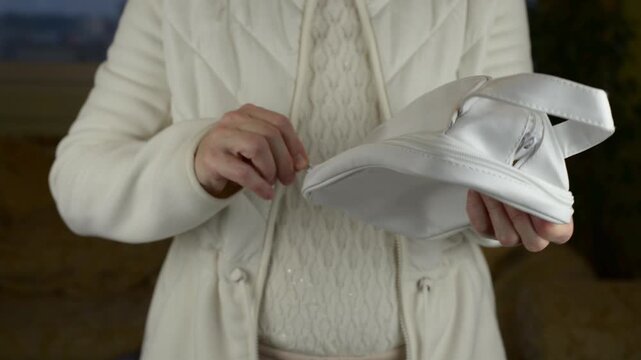 The rhythmic zipping and unzipping of a cosmetic pouch with the muffled friction of the zipper track with sound.