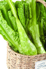 Fototapeta premium Fresh Green Romaine Lettuce in Wicker Basket - Organic Vegetables and Healthy Produce