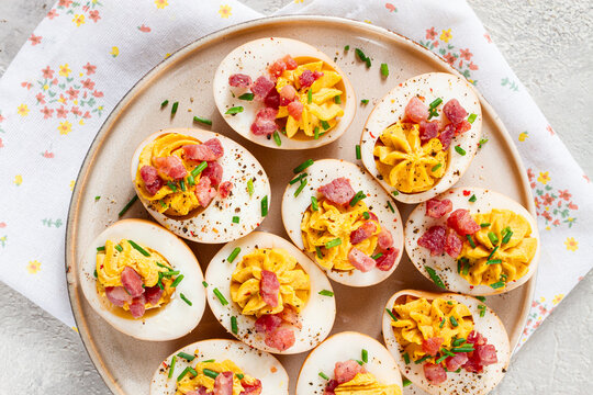 Spicy, stuffed ramen eggs, with bacon and green onions, homemade, no people,