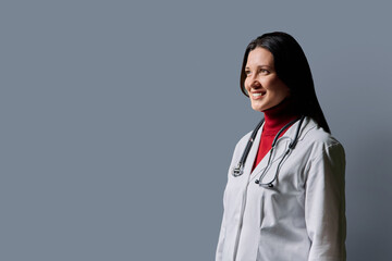 Profile portrait of middle-aged woman doctor on grey studio background © Valerii Honcharuk