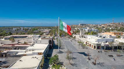 Aerial view of Mexican Flag Waving in Plaza Mijares, San José del Cabo, Baja California Sur, Mexico