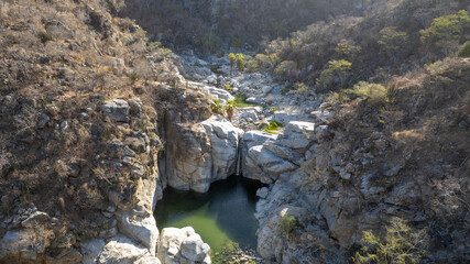 Aerial view of Waterfall and Turquoise Pool in Cañón de la Zorra, Sierra de la Laguna, Baja California Sur, Mexico © Alfredo