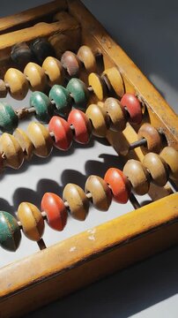 Vintage Chinese Abacus with Red and Green Calculation Beads on Wooden Frame, Traditional Arithmetic Tool.