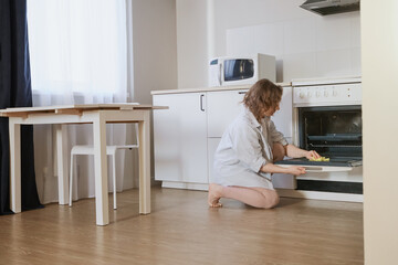 Woman scrubbing inside of kitchen oven with sponge