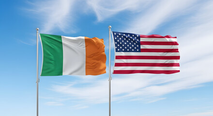Irish and American flags waving together under a blue sky  