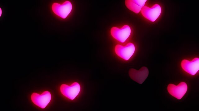 Valentine pink glowing heart shapes floating on blackground
