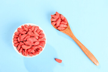 Fototapeta premium Dried Red Goji Berries from Ningxia in Bowl and Wooden Spoon Still Life Food Photography