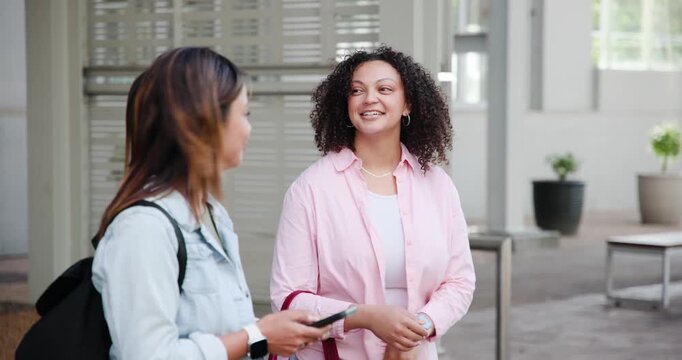 Diverse women friends waiting for arrival at lobby one checking wristwatch other scrolling phone