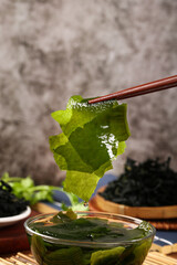 Fresh Wakame Seaweed with Chopsticks - Traditional Asian Kelp Preparation for Healthy Cooking © DangThi