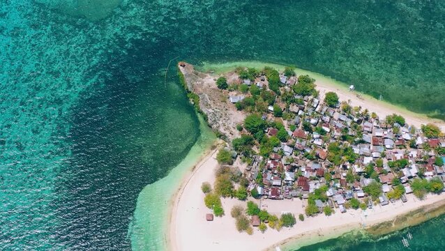 Aerial view of tropical island village by crystal clear sea