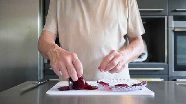 Elderly man placing cooked beetroot on a plate