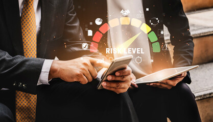 Business professionals analyzing risk levels through digital devices with graphs and icons...