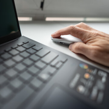 Man's hand pressing the left mouse button on a very close photo.