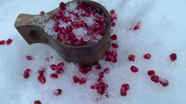 Trying to mix snow and pomegranate fruit in winter and testing the taste.