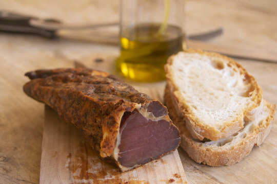 Traditional dried meat with bread and olive oi