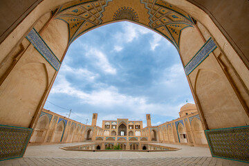 Fototapeta premium Wonderful view of Agha Bozorg Mosque on blue sky background in Kashan, Iran. The historical mosque and madrasa is a popular tourist attraction of the Middle East.