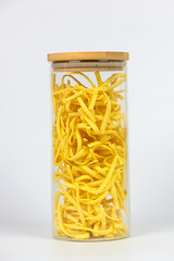 Egg pasta in a glass container on a white background