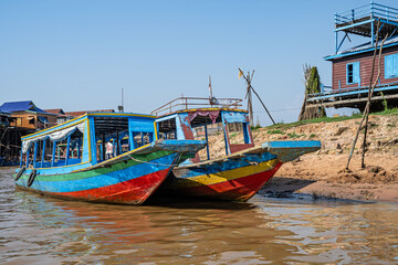 Fototapeta premium Tonle Sap Lake, Siem Reap, Cambodia – Colorful boats on the Siem Reap River near Tonle Sap Lake.