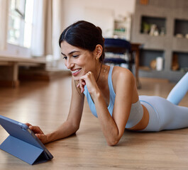 Portrait of a fit latina girl young woman exercising practicing yoga or fitness watching online...