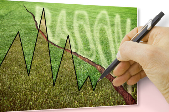 A green mowed lawn with a diagonal crack with radon gas escaping - concept image with hand drawing a chart about radon issue