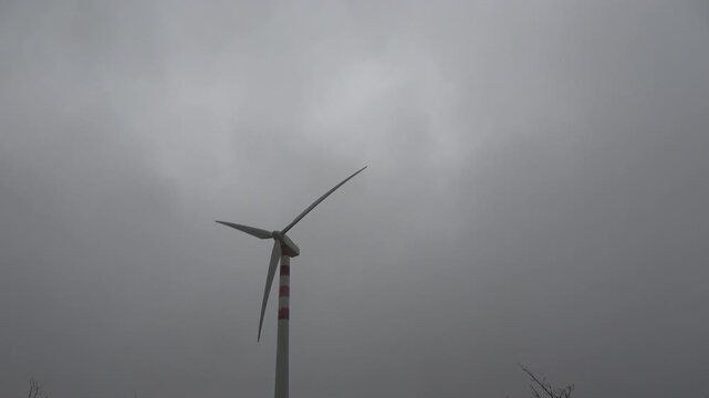 Modern wind turbine in operation on a cloudy day