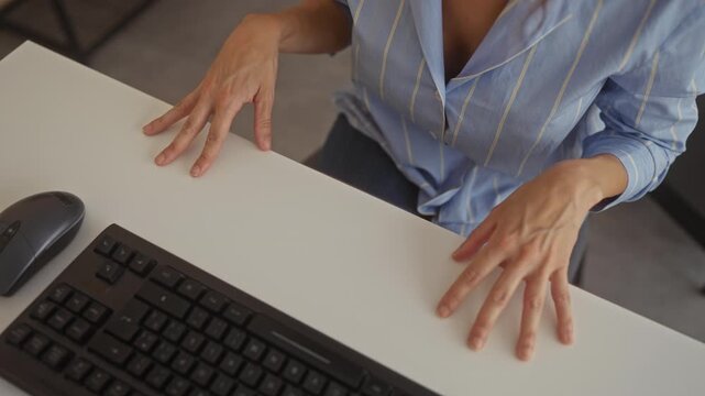 Woman hands gesturing over white desk beside keyboard and mouse in office environment; conversation clarity understanding insight.