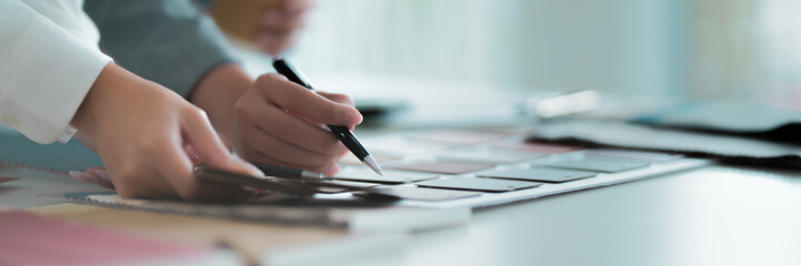 Two professionals discussing interior design strategies and project in office