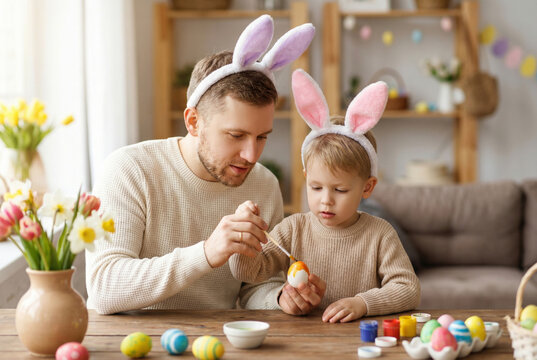 Father and Son Painting Easter Eggs Together