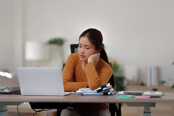 Bored unmotivated female working at home