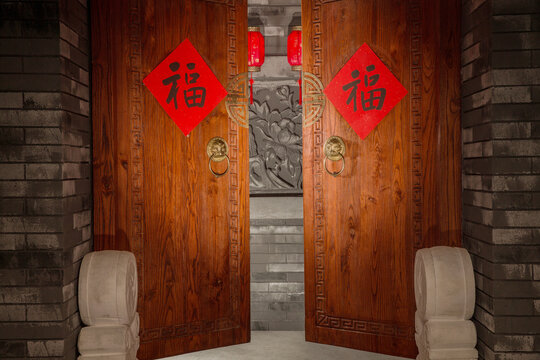 Traditional Chinese Wooden Doors with Red Blessing Couplets