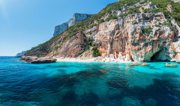 Aerial view of Cala Mariolu, stunning turquoise bay with white limestone cliffs and crystal clear water along the Baunei Coast, Gulf of Orosei, Sardinia, Italy.