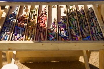 artist easel with pastel crayons in a tray
