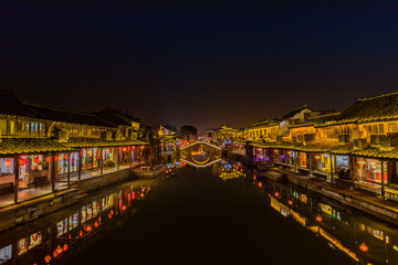 Fototapeta premium Xitang Ancient Water Town Night Canal with Traditional Architecture
