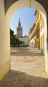 Walking through Patio de Banderas in Seville revealing the Giralda