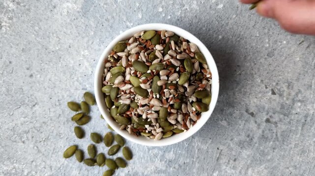 Shelled sunflower, sesame, pumpkin, and flaxseed kernels as ingredients for healthy food. Seeds and grains as food background for your design.