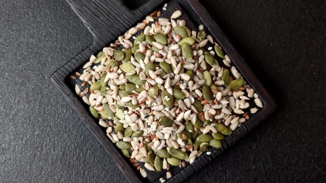 Shelled sunflower, sesame, pumpkin, and flaxseed kernels as ingredients for healthy food. Seeds and grains as food background for your design.