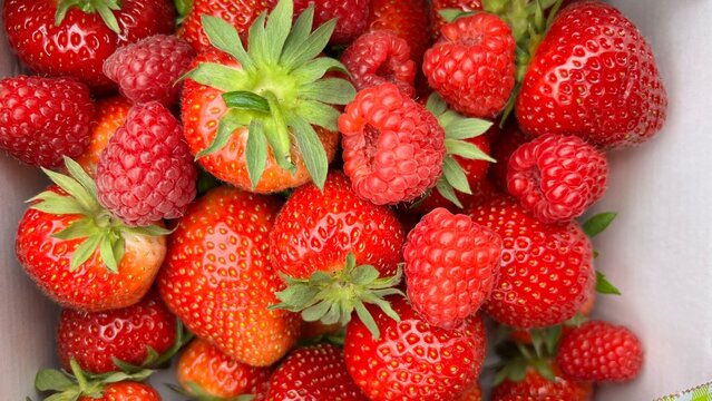 Fresh ripe strawberries and raspberries close up