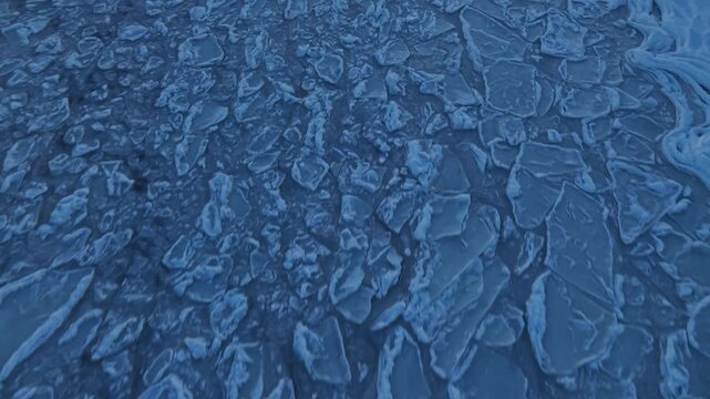Vast network of broken ice sheets captured from high above with intricate natural patterns
