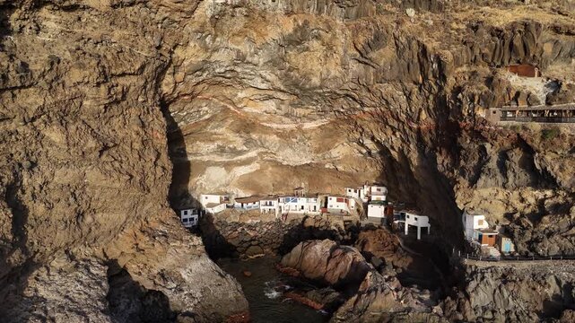 Aerial drone footage of houses built in vulcanic cave in Por&iacute;s de Candelaria, La Palma, Canary Islands