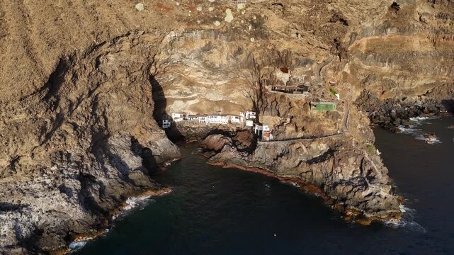 Aerial drone footage pulling away from cave houses in Por&iacute;s de Candelaria, La Palma, Canary Islands