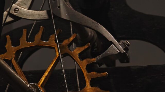 Extreme close-up video of large, antique clockwork gears moving inside a city clock tower. The ticking sound and motion symbolize the relentless passage of time.