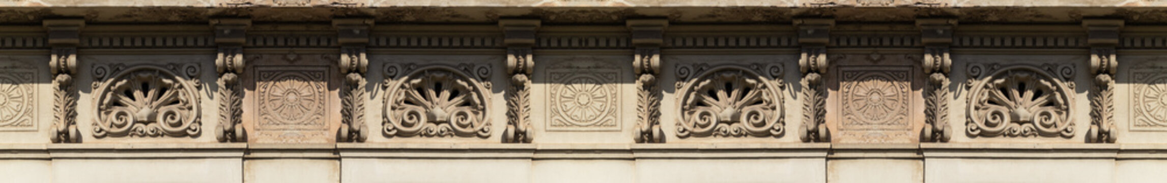 Elements of architectural decorations of buildings, columns and capitals, gypsum moldings, wall textures and patterns. On the streets in Barcelona, public places.